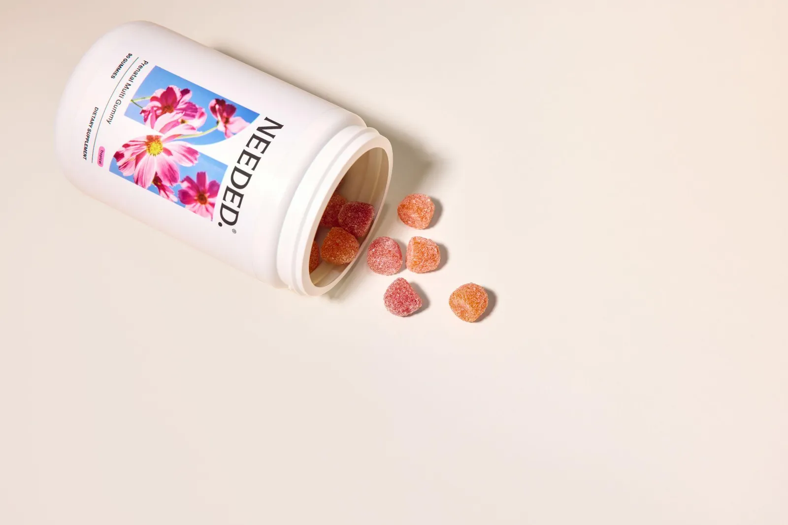 Woman taking a Needed prenatal gummy